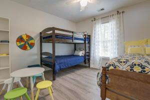 a bedroom with a bunk bed and a table and chairs at Pet-Friendly LaGrange Vacation Rental with Deck! in LaGrange