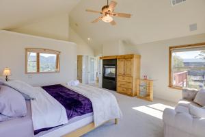 a bedroom with a bed and a ceiling fan at Lake Arrowhead Home with 3 Decks and Stunning Views! in Lake Arrowhead