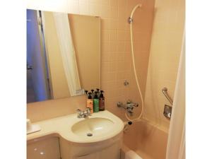 a bathroom with a sink and a toilet and a shower at Hotel Tetora Spirit Sapporo - Vacation STAY 59337v in Sapporo