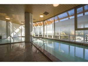 a swimming pool in a building with a large window at Kinugawa Onsen Yusuikiko Hotel Otaki - Vacation STAY 68843v in Nikko