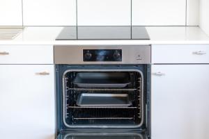 an oven with its door open in a kitchen at Beautiful Bath garden flat with stunning views - Mycityhaven in Bath