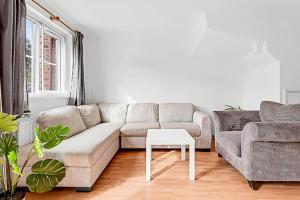 ein Wohnzimmer mit einem Sofa und einem Tisch in der Unterkunft Beautiful Richmond House in Richmond upon Thames