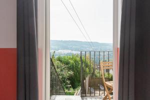a view from a window of a balcony with a chair at Beautiful Bath garden flat with stunning views - Mycityhaven in Bath