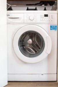 a white washer and dryer in a room at Beautiful Bath garden flat with stunning views - Mycityhaven in Bath
