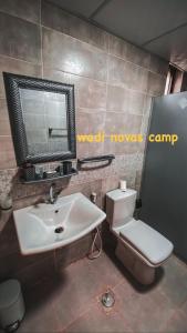 a bathroom with a sink and a toilet and a mirror at wadi novas camp in Wadi Rum +31 photos
