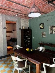 a dining room with a wooden table and chairs at Departamento Arcano in Mexico City