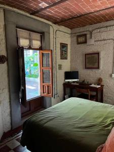 sypialnia z łóżkiem, biurkiem i oknem w obiekcie Departamento Arcano w mieście Meksyk