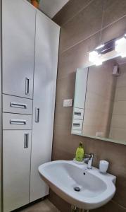 a bathroom with a white sink and a mirror at Planinska kuća II in Jahorina +13 photos