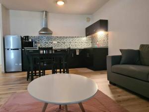 a living room with a couch and a table at Appartement F2 Ninirei in Papeete +9 photos