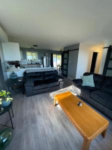 ein Wohnzimmer mit einem Sofa und einem Tisch in der Unterkunft Sunrise Mountain view Skidegate House 