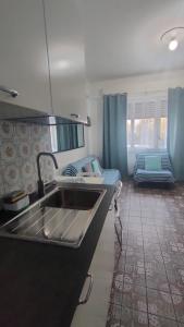 eine Küche mit einem Waschbecken und ein Bett in einem Zimmer in der Unterkunft BREZZA SUL MARE in Fiumaretta di Ameglia