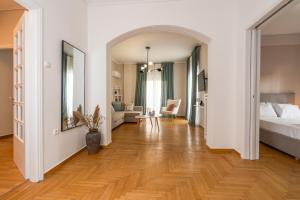 a bedroom with a bed and a living room at Athenian Classy 2BD Apt next to Metro Panepistimio in Athens