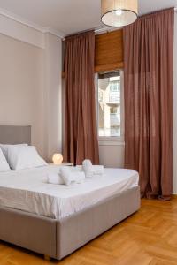 a bedroom with a large bed in front of a window at Athenian Classy 2BD Apt next to Metro Panepistimio in Athens