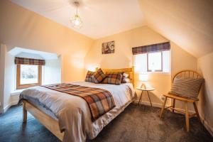 a bedroom with a large bed in a attic at Croft House, Armadale Bay in Armadale