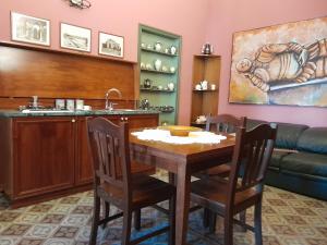 a dining room with a table and a sink at Casa Castelli Appartamento vacanza in Bagheria +5 photos