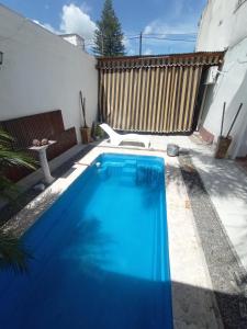 a small blue swimming pool in a backyard at Departamentos la cascada in Termas de Río Hondo