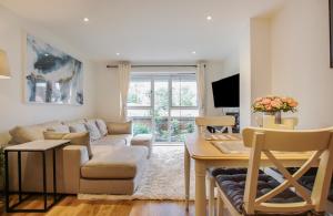 a living room with a couch and a table at Luxurious 1 Bedroom West Bridgford Apartment in Nottingham