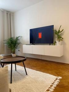 a living room with a tv with a n on it at AR Comfort House in Košice