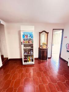 an empty room with a refrigerator with drinks in it at HOSTEL GOLDEN STAR in Gião
