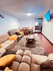 a living room with a couch and a table at HOSTEL GOLDEN STAR in Gião