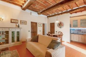 a living room with a couch and a table at Holiday Home Villa il Cesto in Greve in Chianti