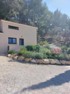 a house with a bunch of plants in front of it at La Belle de Cassis in Cassis