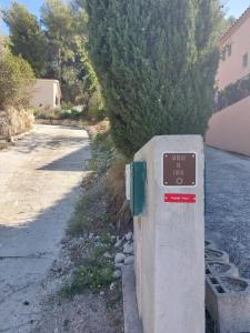 a sign on a wall next to a street at La Belle de Cassis in Cassis