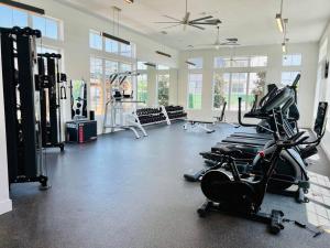 a gym with treadmills and machines in a room at Charming Home: 2BD/2BA in Kyle, TX! in Kyle