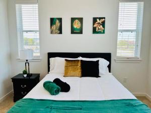 a bed with two pillows on it in a bedroom at Charming Home: 2BD/2BA in Kyle, TX! in Kyle