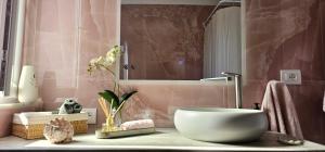 a bathroom with a white bowl on a counter at Nuçi's Place, lovely apt with balcony near Blloku in Tirana +25 photos