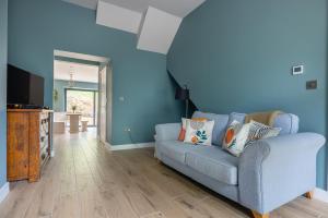 a blue living room with a couch and a television at H2-Roof Top-3 Bedrooms-2BA-Free Parking-Sleeps 6 