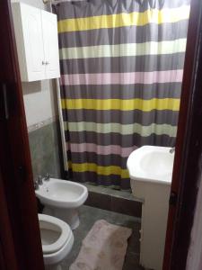 a bathroom with a toilet and a sink at LO DE LOPEZ in Azul +18 photos