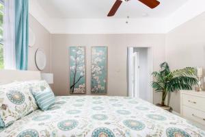 a bedroom with a bed and two paintings on the wall at Shotgun Craftman House with Private Patio in New Orleans