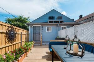 a patio with a blue table and a fence at Shotgun Craftman House with Private Patio in New Orleans