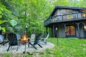 a group of chairs sitting around a fire in front of a house at Zen Spa Oasis Retreat Sauna/Hotub/Firepit/Fun/Gameroom in Blakeslee