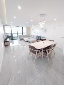 a white living room with a table and chairs at Alupang Beach Tower, UPGRADED units in Tamuning