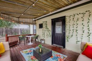 a porch with a door and a table and chairs at Beautiful - 4bd with Contemporary Interior in Lincoln
