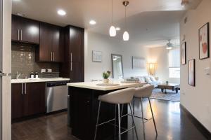a kitchen with a island with two stools at Luxury Apartment West Hollywood in Los Angeles