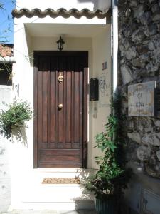 a wooden door on a building with a stone wall at Holiday Home Carina in Dolceacqua
