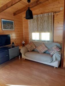 a living room with a couch and a flat screen tv at REFUGIO La Pared in La Pared