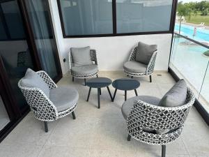 a group of chairs and tables on a balcony at Apartamento, cana rock Star in Punta Cana