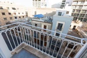 a balcony with a view of a city with buildings at Top location! Cozy 1-BR flat in Il-Gżira