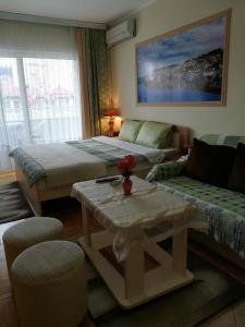 a living room with two beds and a coffee table at Lazo's Apartments in Ohrid