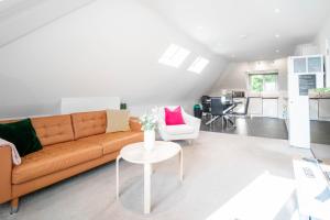 ein Wohnzimmer mit einem Sofa und einem Tisch in der Unterkunft Garland Penthouse - Large 2 bed 2 bath self contained flat in Redhill