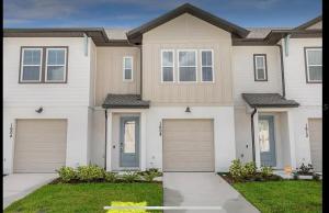 a house with two garage doors in a yard at FREE Amenities with Kids Waterpark in Luxury House in Davenport
