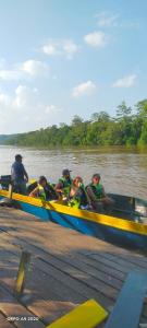 a group of people in a boat on the water at Sukau tomanggong view bed & breakfast in Sukau