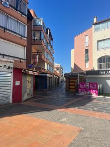 an empty street in front of some buildings at Studio Chaleureux au Cap d’Agde in Cap d'Agde