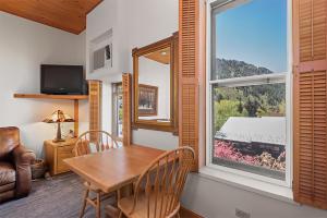 a dining room with a table and a window at Independence Square 301, Great Hotel Room with Excellent Location & Rooftop Hot Tub in Aspen