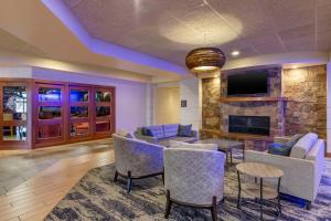 a living room with furniture and a fireplace at Best Western Plus Butte Plaza Inn in Butte