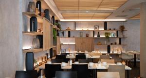 a restaurant dining room with tables and chairs at Best Western Premier Hotel de la Paix in Reims